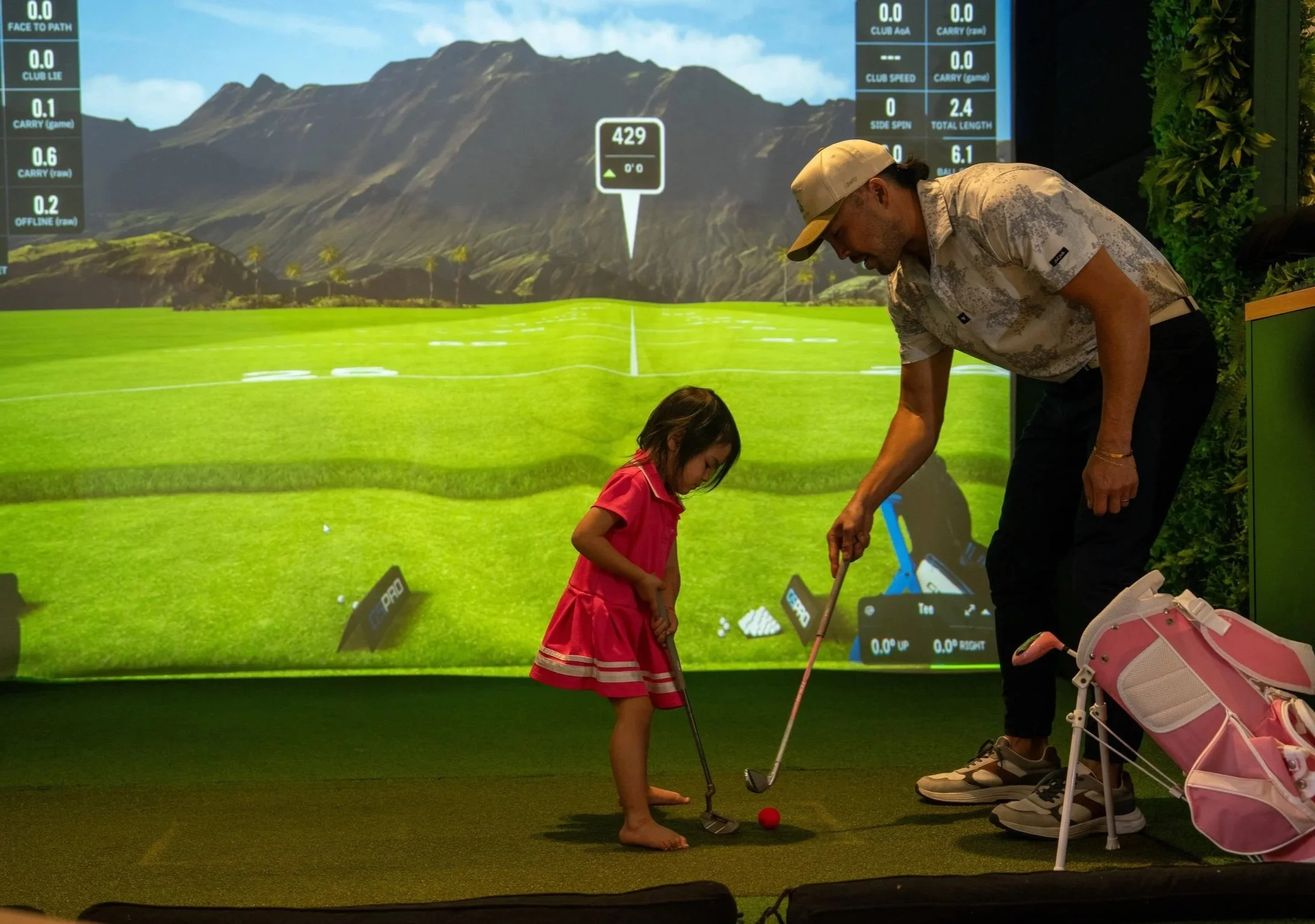Friends and families enjoying indoor golf simulator bays at Beachside Greens in Pacific Beach San Diego