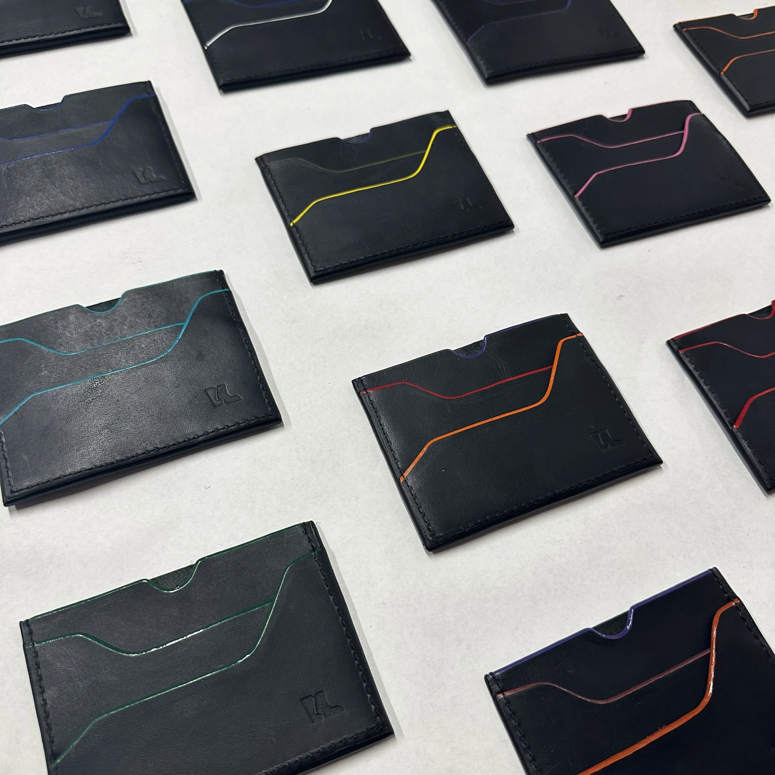 Edge-Painted Wallets - 
Handcrafted leather goods with hand-painted edges.