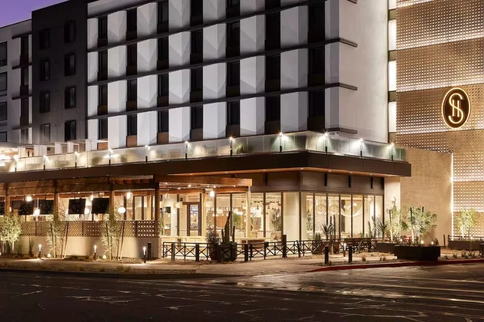 Exterior of Senna House, a Curio Collection by Hilton in Old Town Scottsdale, featuring contemporary architecture and boutique hotel entrance at night.