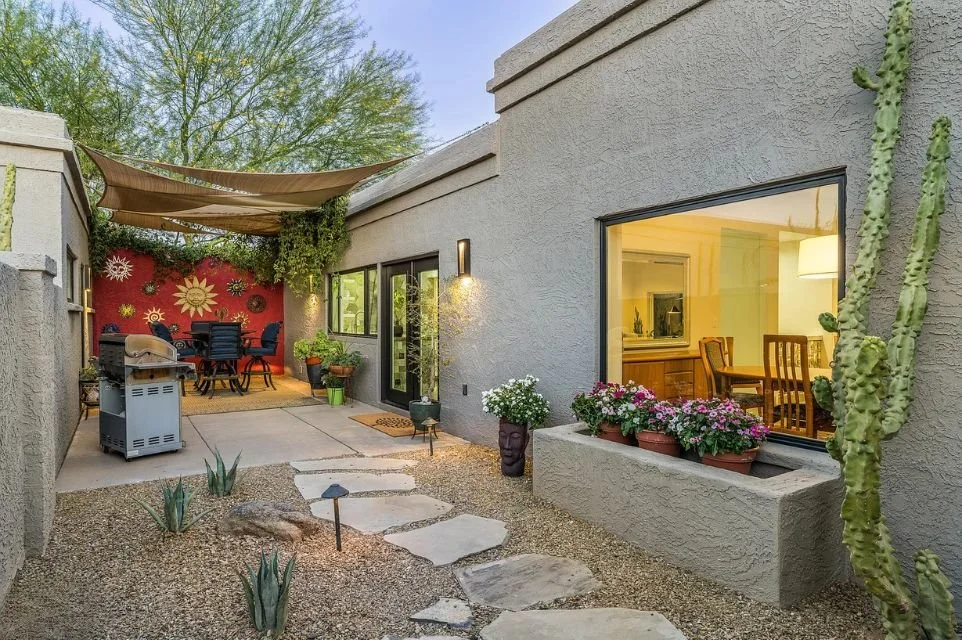 Scottsdale courtyard patio with desert landscaping, shade canopy, outdoor dining area, cactus garden, and private indoor-outdoor living space in McCormick Ranch Arizona