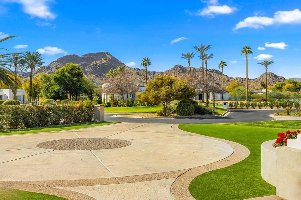 Paradise Valley, Arizona neighborhood with palm trees, landscaped grounds and mountain views