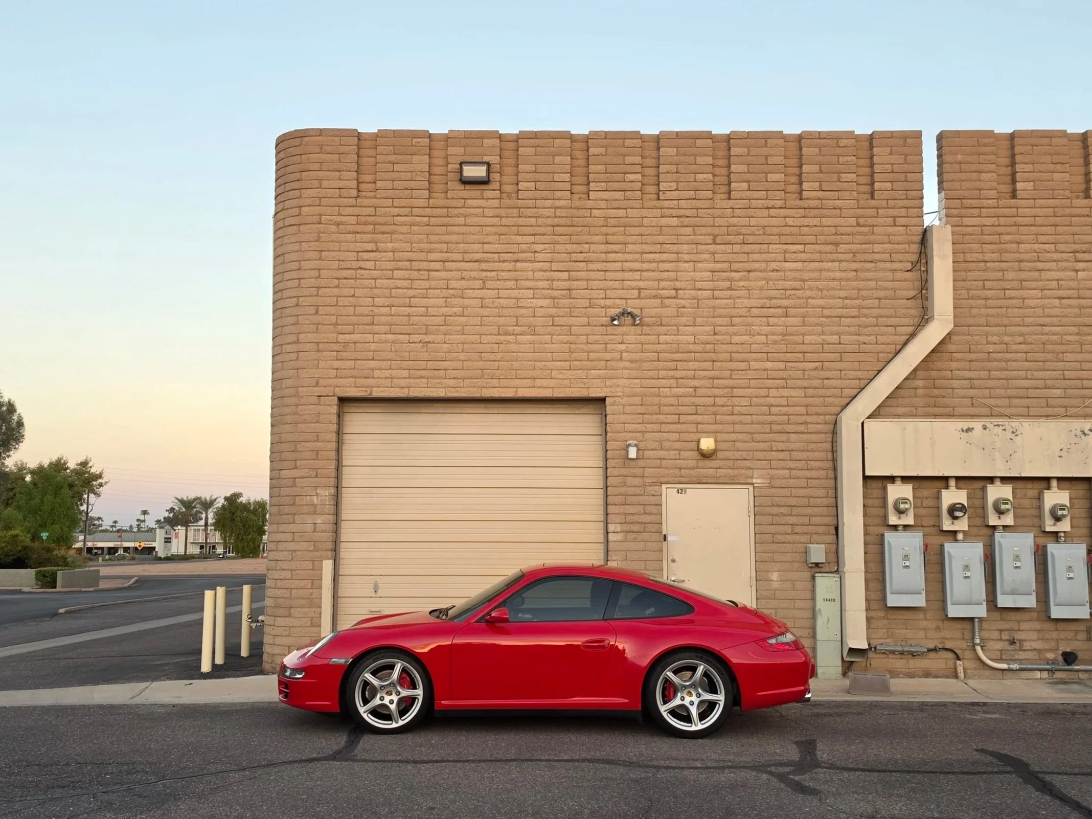 Red Porsche 911 parked in front of a garage in Scottsdale, Arizona