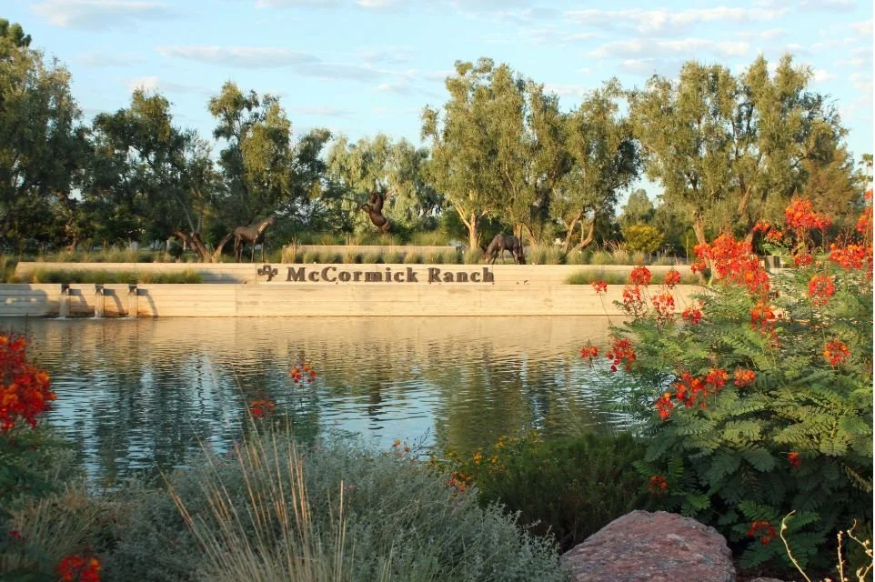 McCormick Ranch entrance with waterfront landscaping and horse sculptures in Scottsdale, Arizona