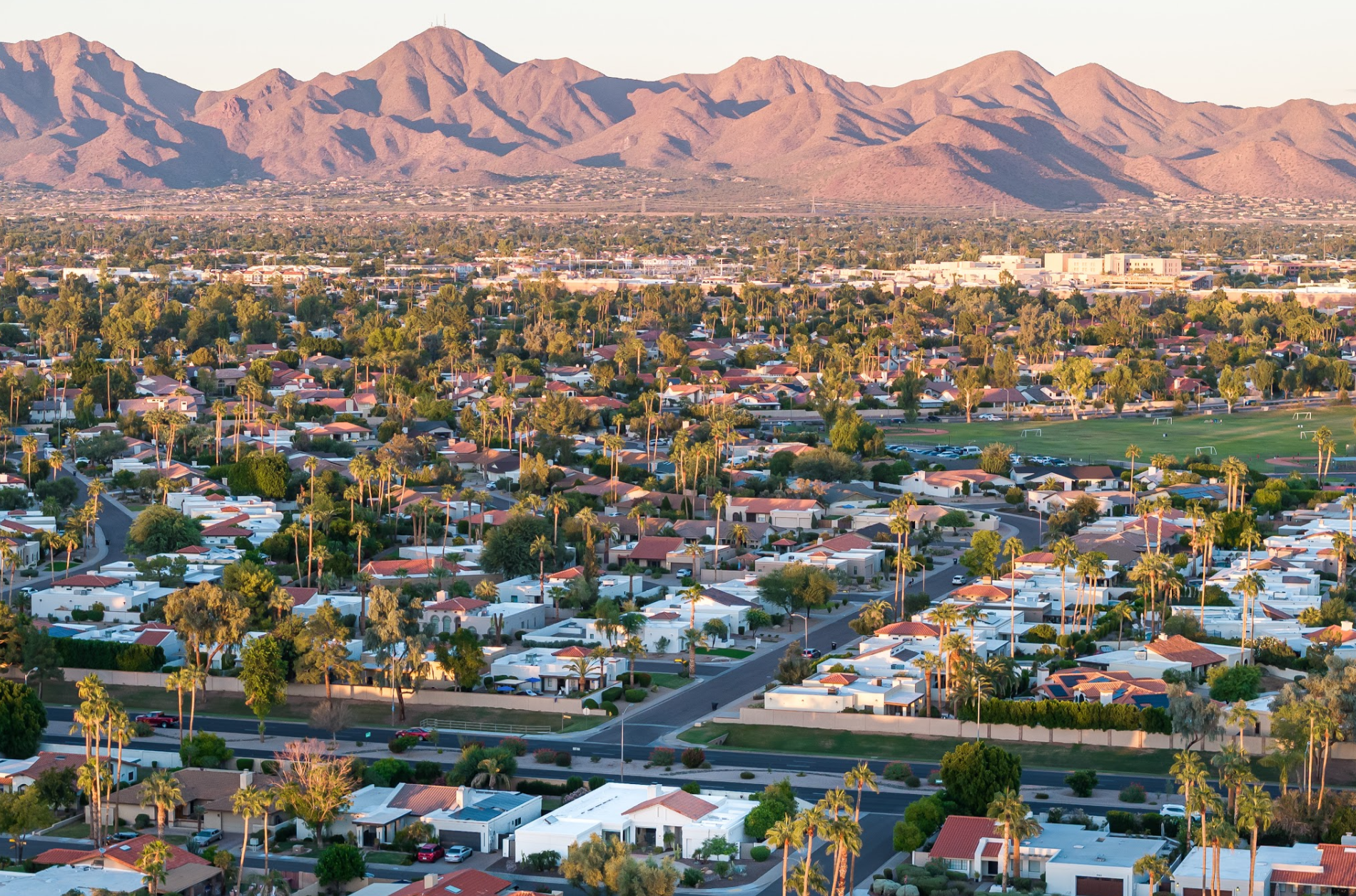Aerial view of McCormick Ranch, Scottsdale, showing mature tree canopy and residential streets with the McDowell Mountains in the background