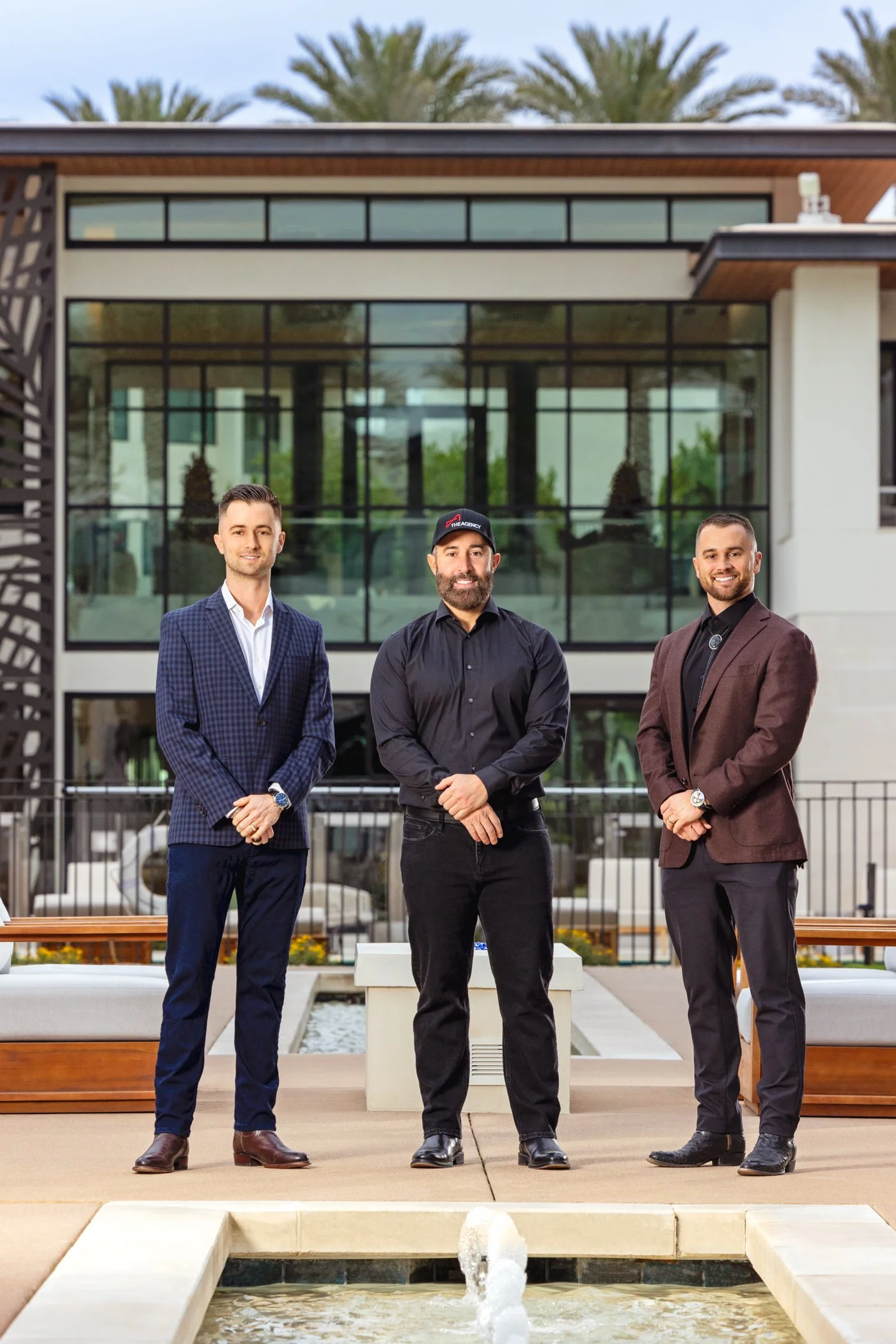 Luxury real estate team in Scottsdale Arizona standing in front of a modern luxury home in Scottsdale, Arizona.