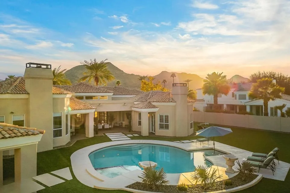Paradise Valley home with swimming pool and mountain views at sunset