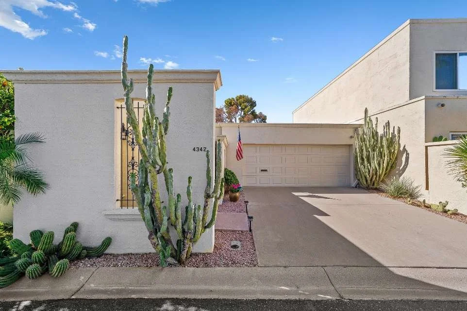 Southwestern stucco home exterior with desert cactus landscaping and private driveway in Villa Adrian Scottsdale