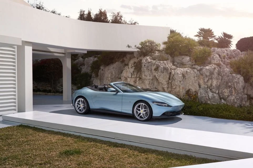 Ferrari Roma Spider parked outside a contemporary luxury home, showcasing Scottsdale's luxury lifestyle and exotic car culture.