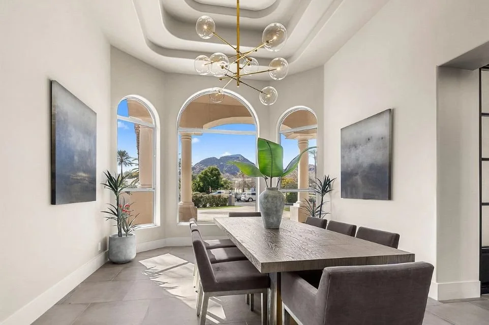 Dining room in a Paradise Valley luxury home with arched windows and mountain views