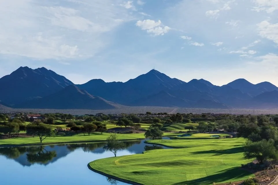Golf course fairway and lake with desert mountains in the background in the Scottsdale area