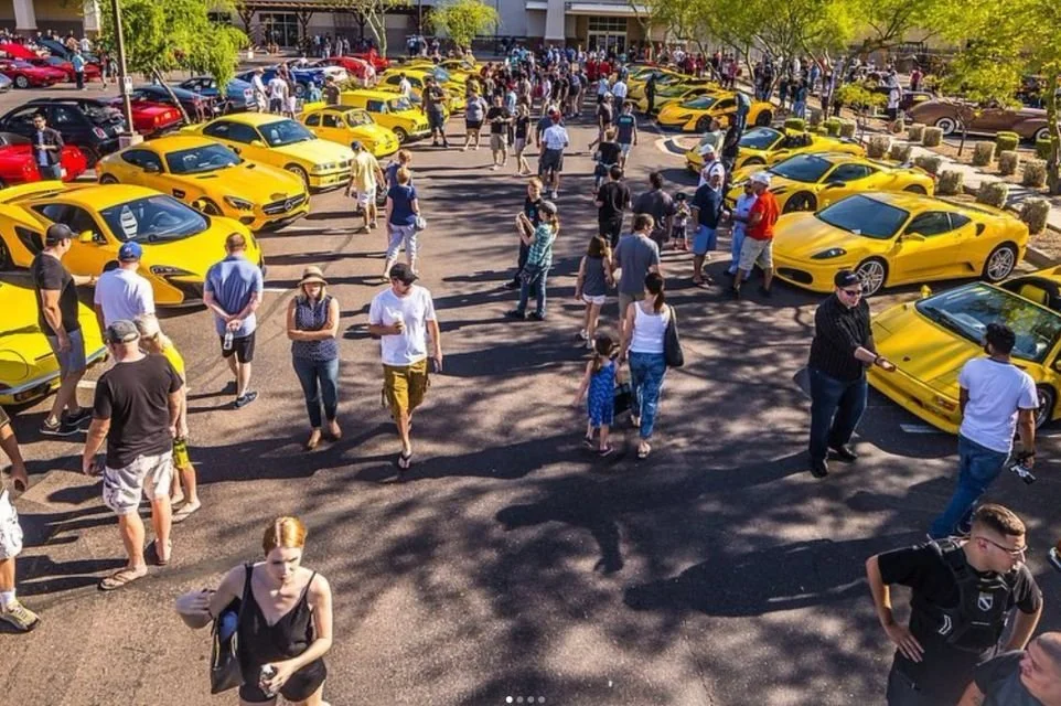 Crowds exploring luxury, exotic, and classic vehicles during a Scottsdale Cars & Coffee event in Arizona.