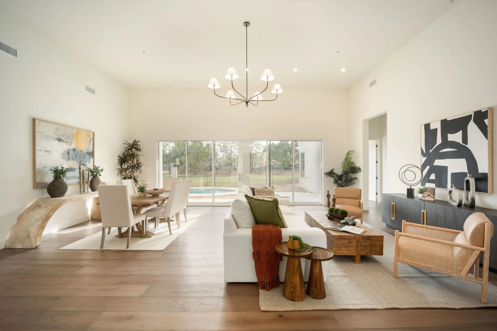 A living room with white oak floors and designer furniture