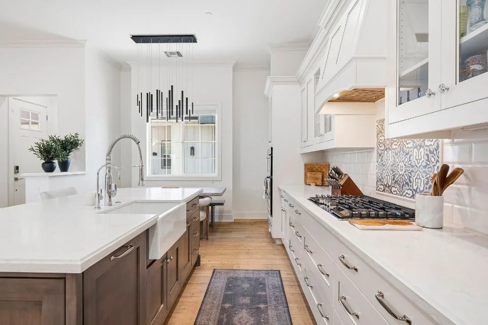 Luxury Scottsdale kitchen with farmhouse sink, quartz countertops, custom cabinetry, professional gas range, and oversized center island.