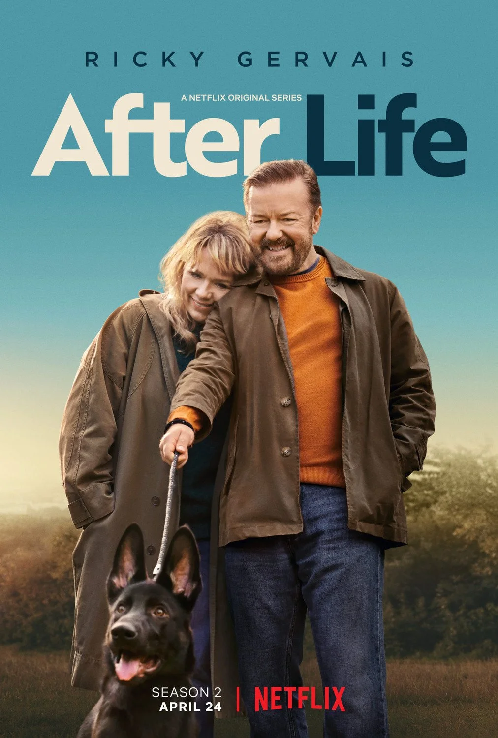 Poster for the Netflix series "After Life" showing a man and woman standing outdoors with a dog. The man has reddish hair and a beard, wearing an orange shirt and brown jacket. The woman has blonde hair, wearing a coat. The background is a landscape with trees and a gradient sky. The title "After Life" is at the top, with the name Ricky Gervais above it. The poster mentions season 2, April 24 release date, and Netflix logo.