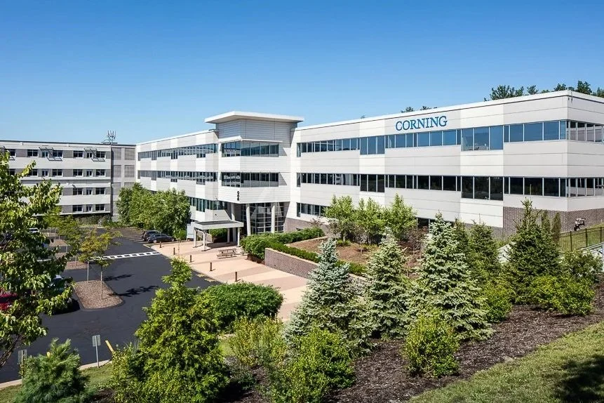 The Center at Innovation Drive, Building 300, Tewksbury, MA:  We inherited a partially demolished concrete block Office & Warehouse Facility and converted it into a modern & sleek aluminum & glass Office Building for Corning with sought after ameniti
