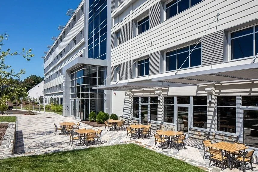 The Center at Innovation Drive, Building 400, Tewksbury, MA:  We re-imagined & converted an existing concrete block Office & Warehouse Facility into a modern & sleek aluminum & glass Office Building with sought after amenities and outdoor gathering s