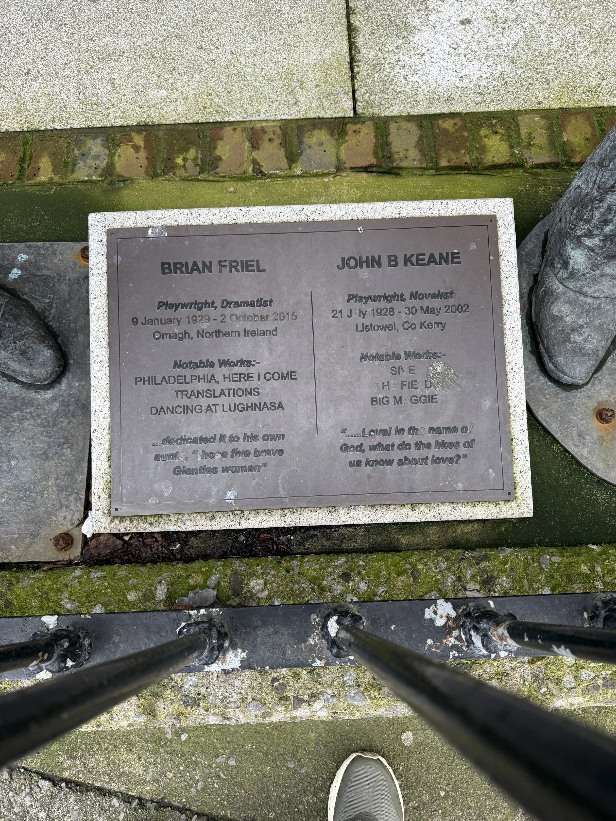 plaque at foot of the statue