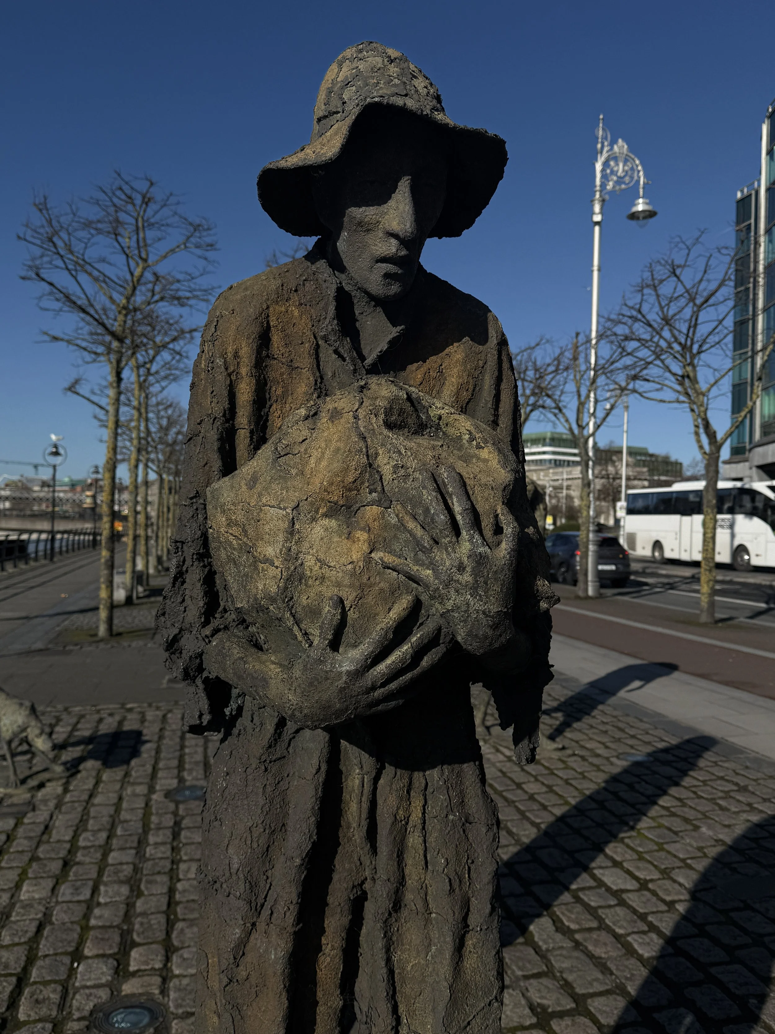 Statue of the famine memorial, a man holding something