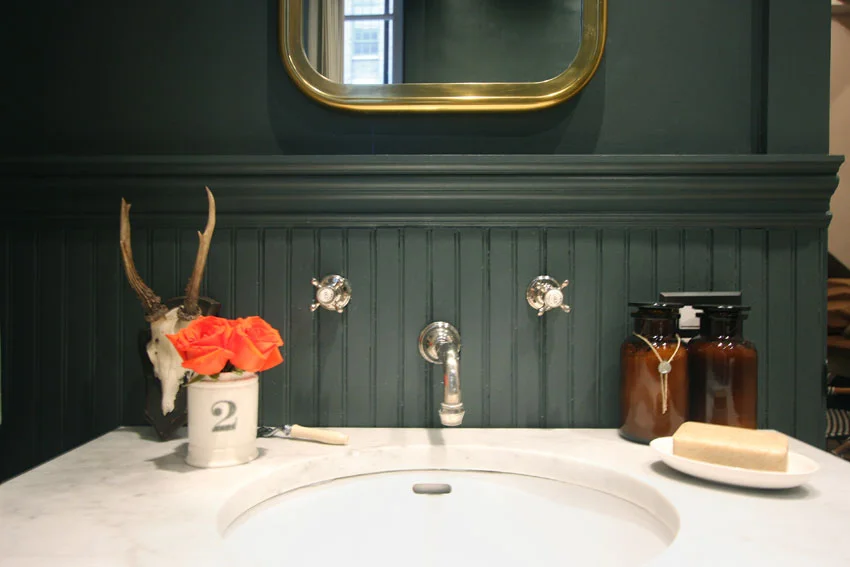 One of my favorite bathroom vignettes. So masculine...then wham! Those vivid orange roses.&nbsp;