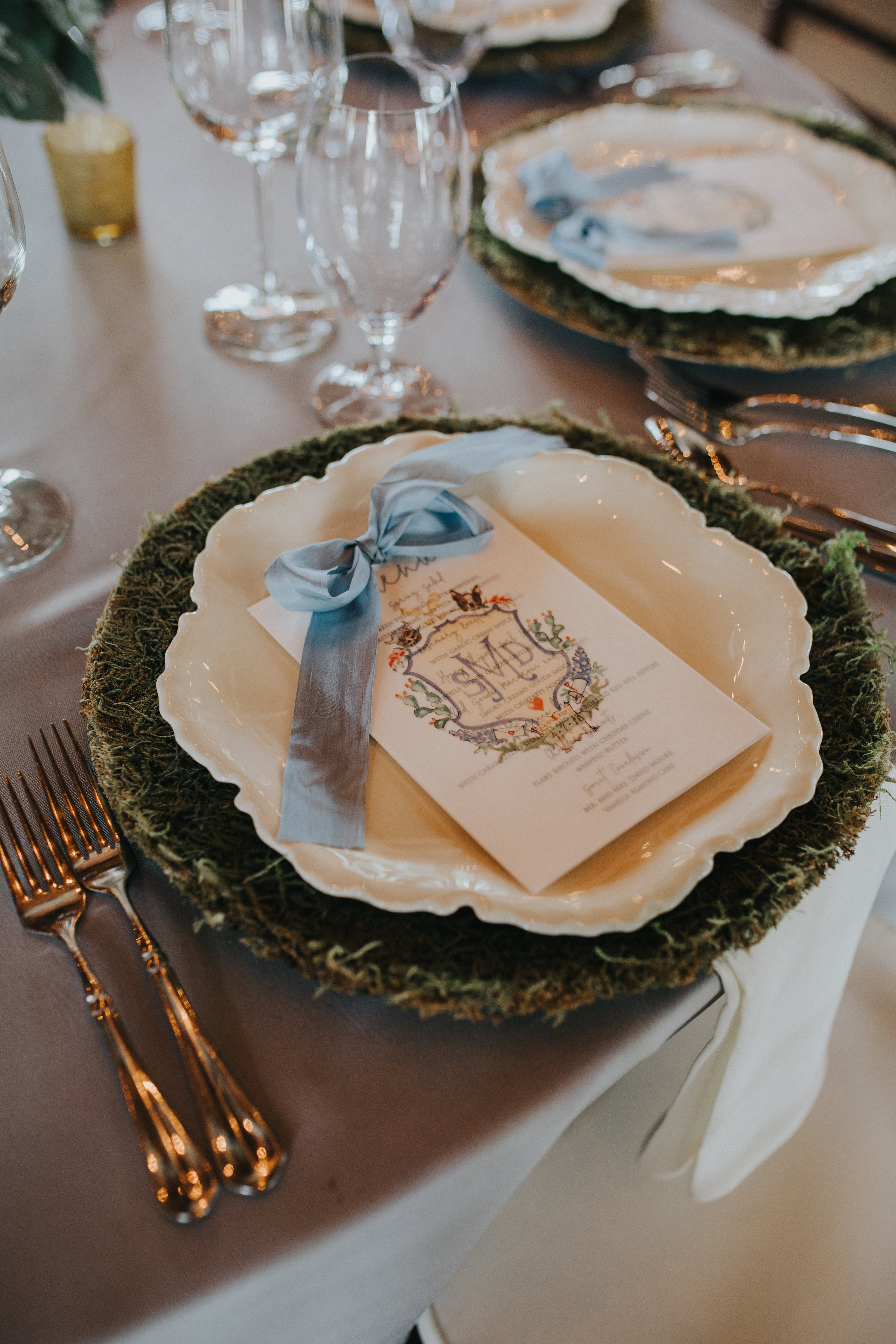 The custom menus featured the crest printed on a vellum overlay, tied together with a silk ribbon.