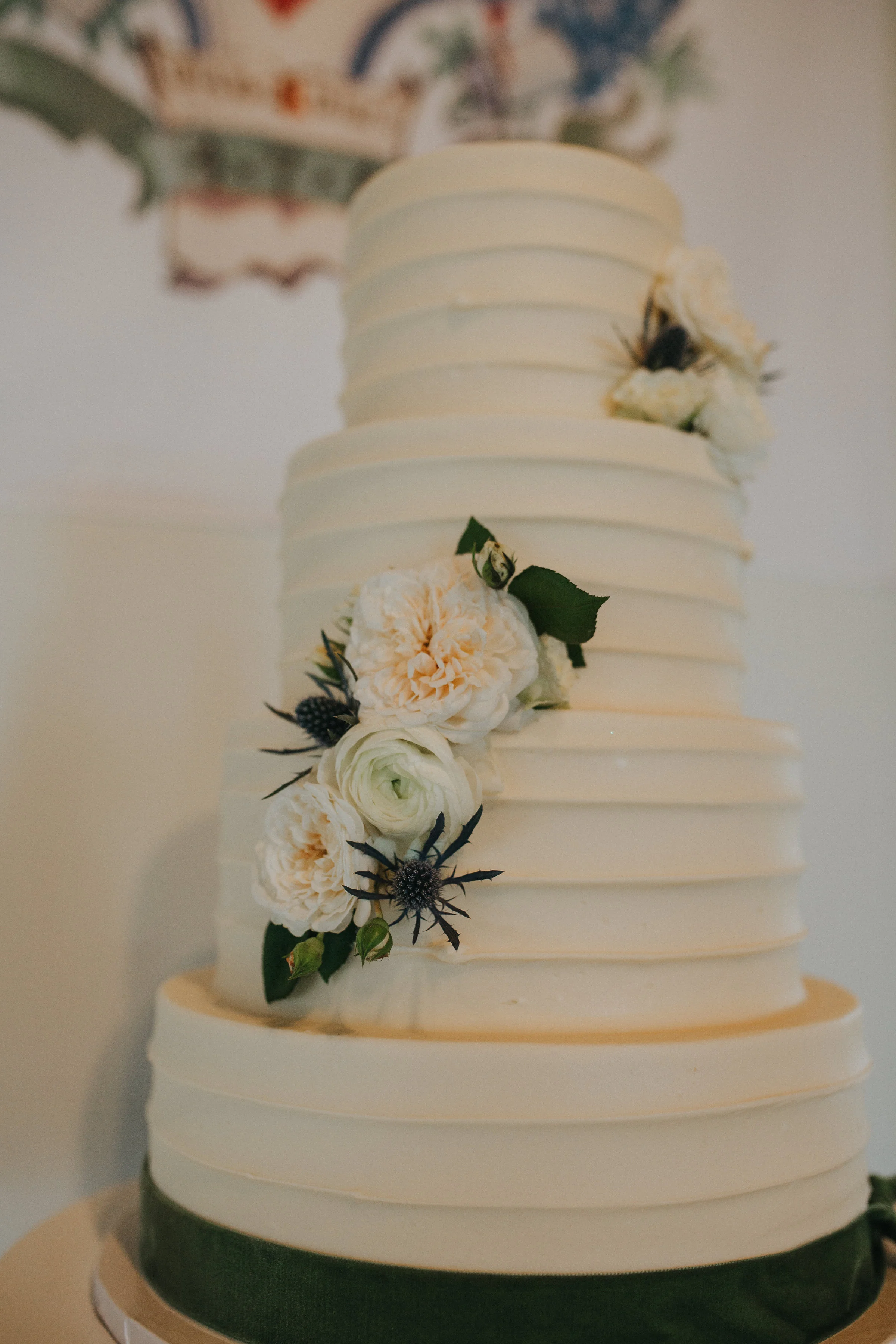 Our almond vanilla cake adorned with velvet ribbon and florals. Cake by Sweet Treets out of ATX.&nbsp;