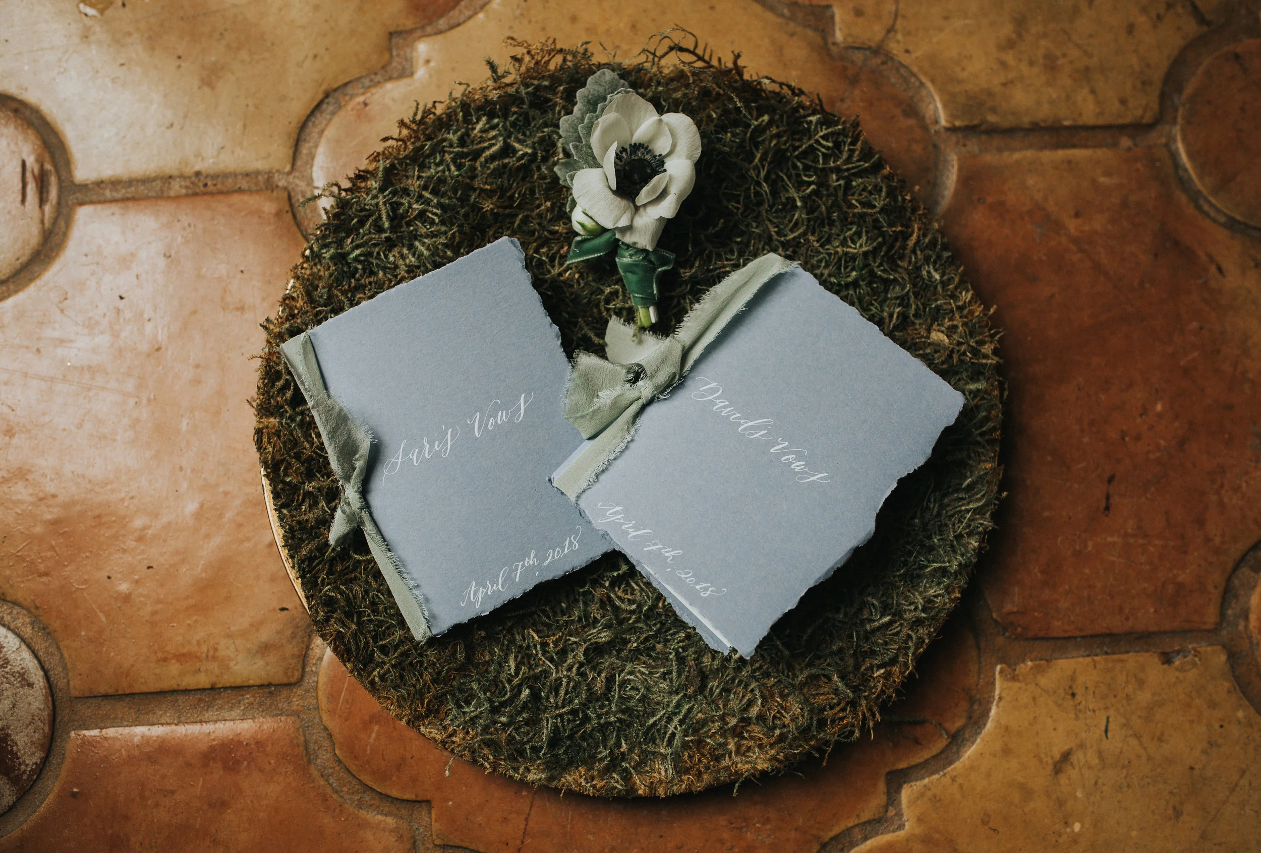 Handmade vow books by Kelsey Carpenter with deckled paper, silk ribbon and hand calligraphy.&nbsp;