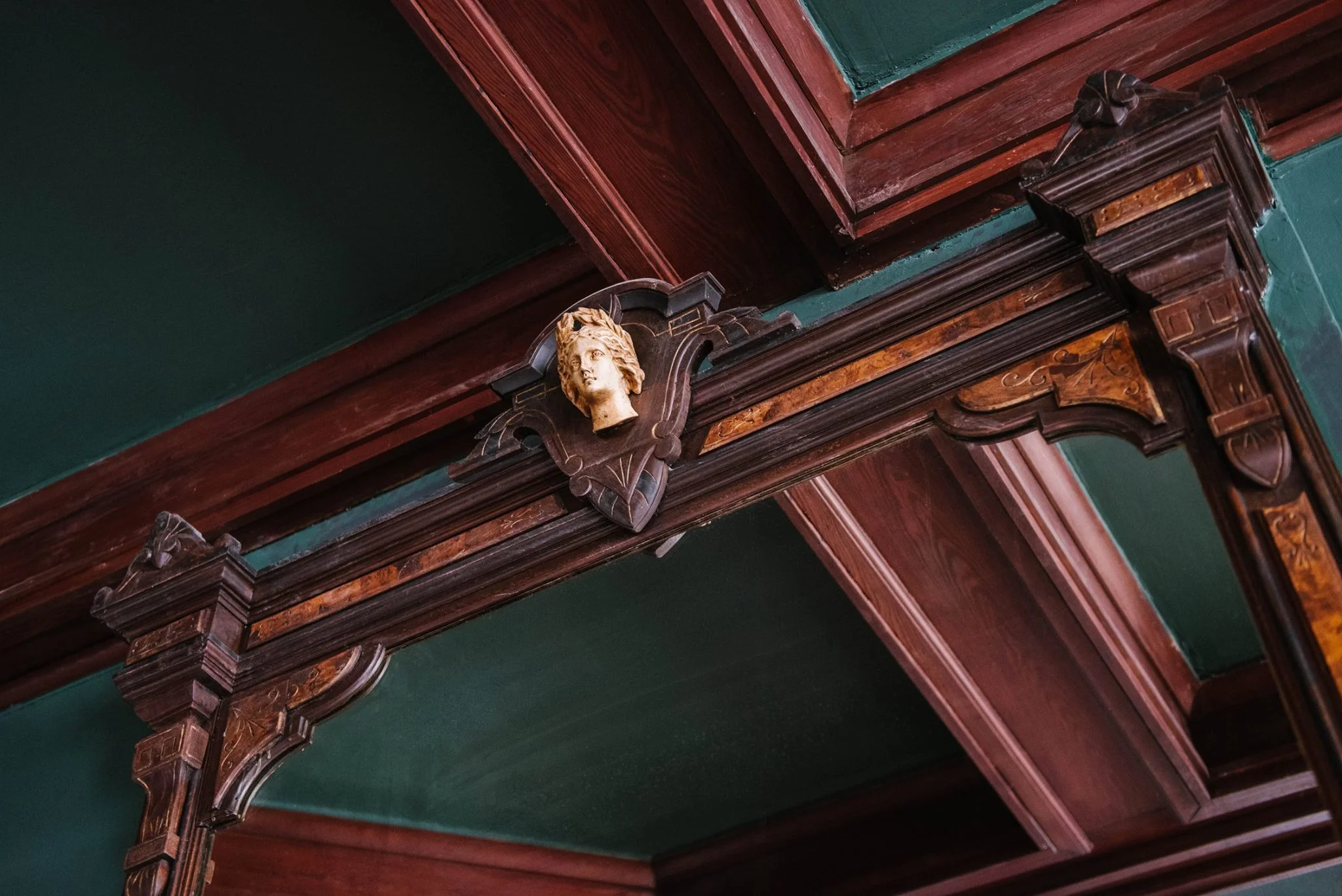 Hestia, Greek Goddess of the Hearth, is an ivory carving detail over the antique fireplace in the pub. Photo by Maggie Kloss / Source: Carr Mansion&nbsp;