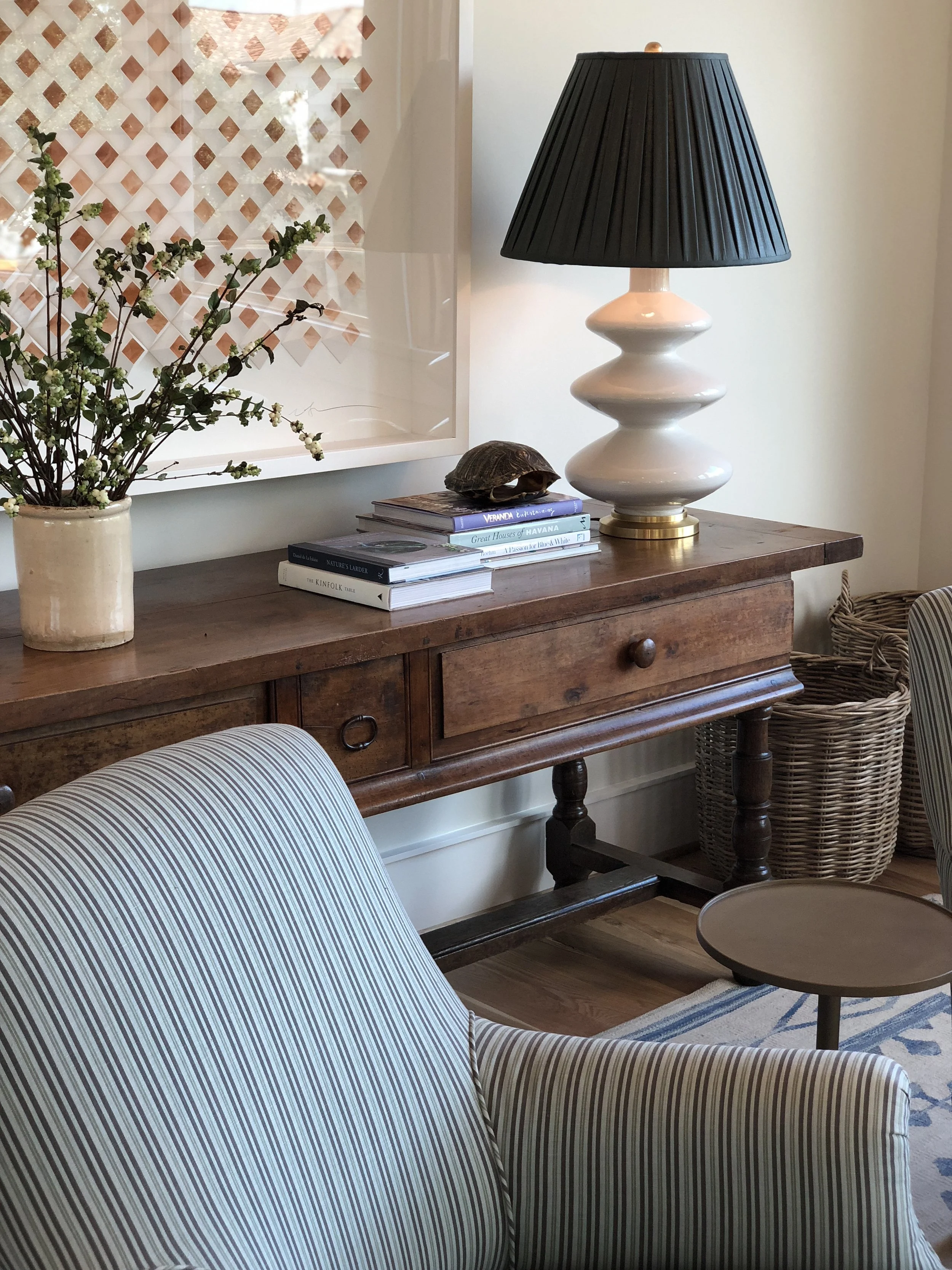 Meg’s upstairs family room — art by Dimmitt Art, console from Joyce Horn Antiques.