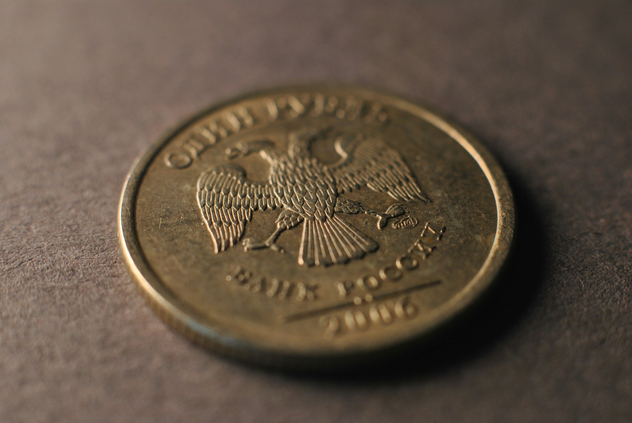 Close-up of a U.S. quarter coin showing the eagle, with the text 'United States of America' and 'Quarter Dollar' visible.