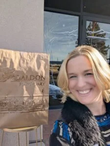 Dr. Genna Reeves in front of a brown paper sign.