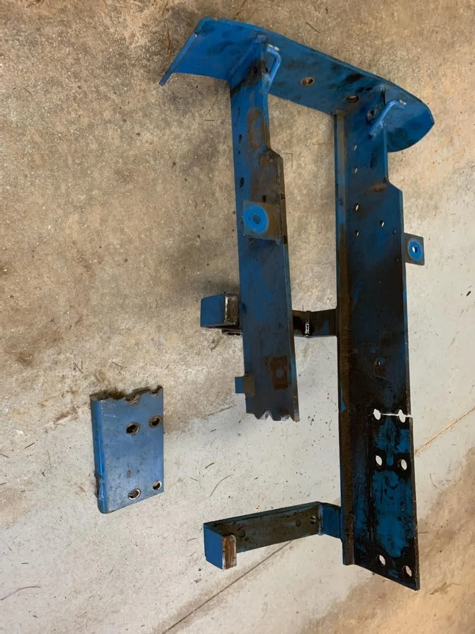 Blue metal frame and brackets on concrete floor