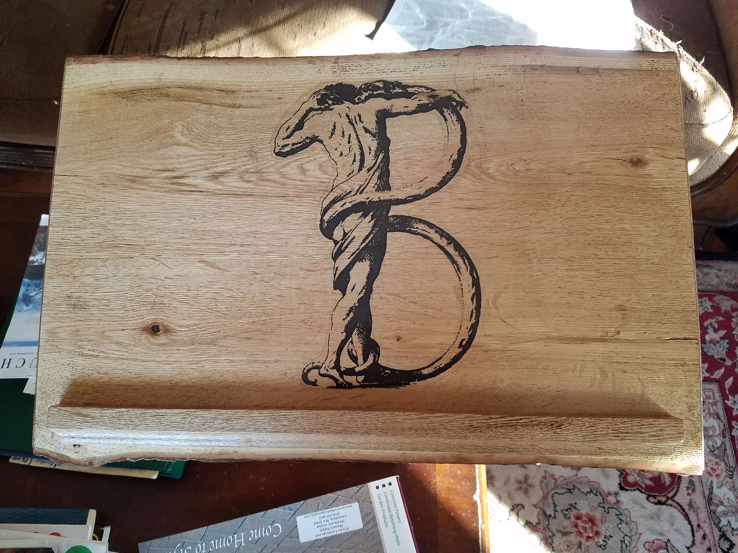 Wooden box with a black graphic of a goose standing on one leg.