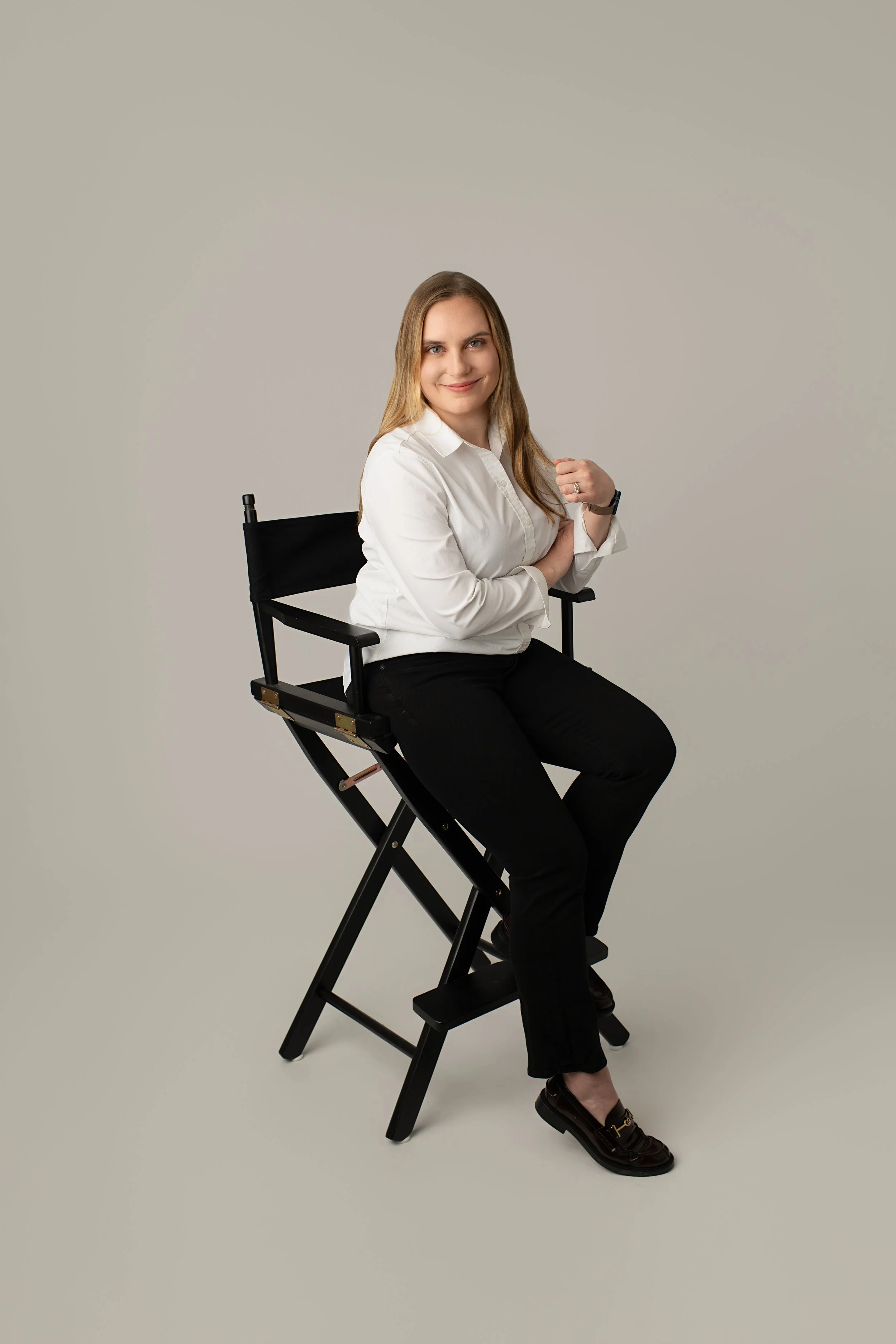 Licensed NJ Therapist who is a woman sitting in a chair wearing a white shirt and black pants