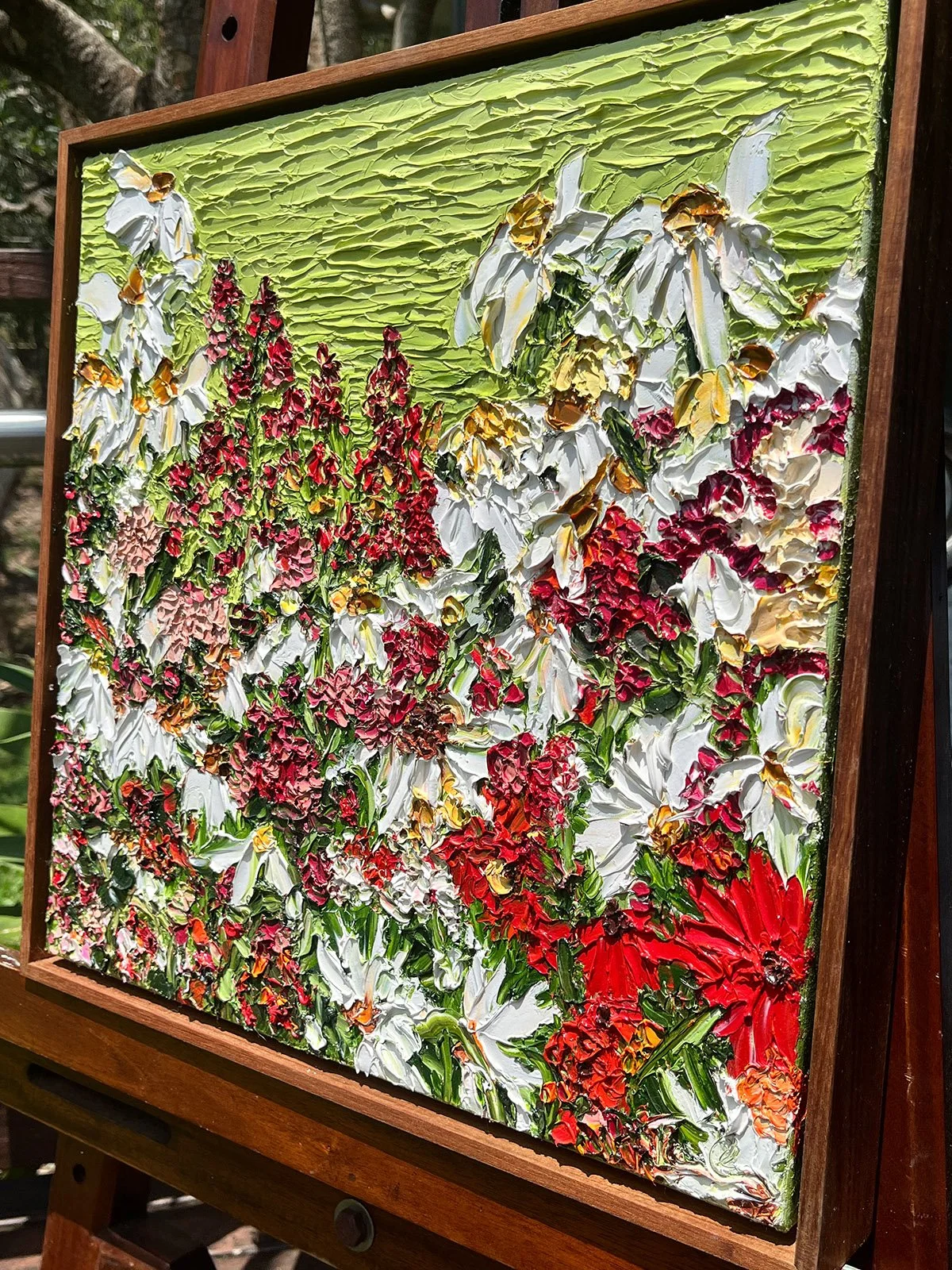 SOLD - 'Flash of Adoration', 43cm x43cm Oil, framed in Blackwood.
Crimson reds, neon green and daisies taking centre stage. A bright oil painting with loads of texture and fun. This work will enliven your space. 