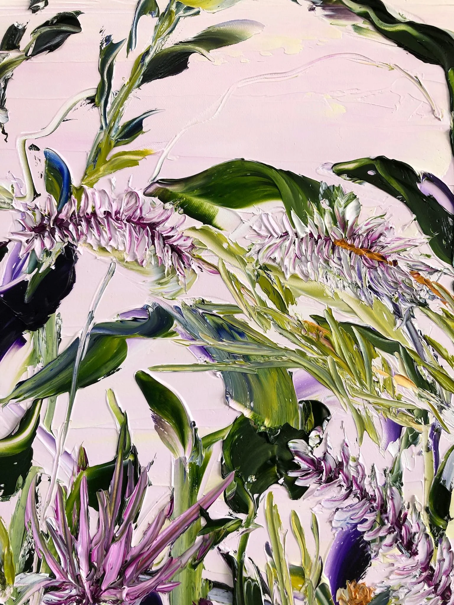 Abstract painting of pink and purple flowers and green leaves on a pink background.