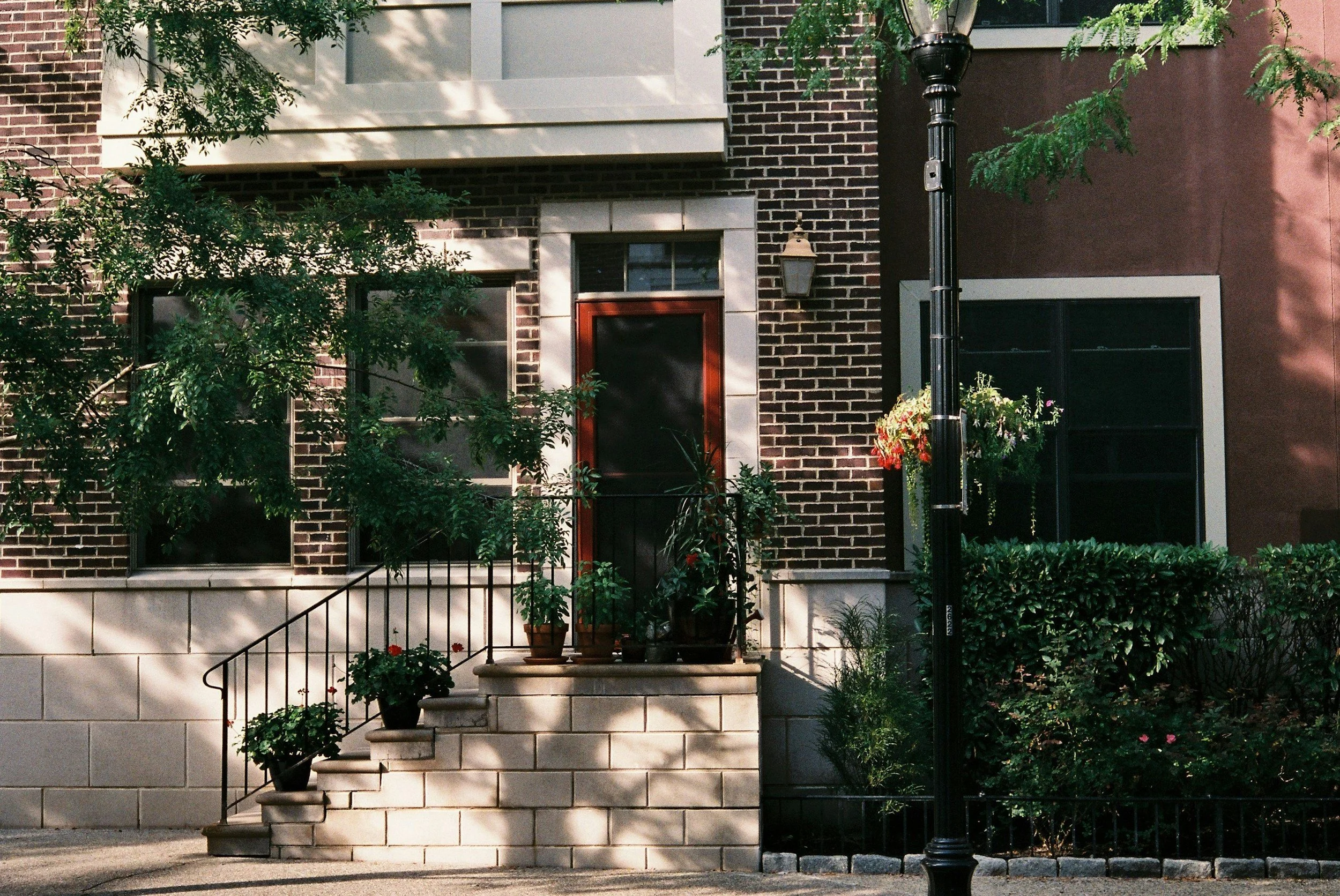 Facade of a brick house with stairs leading up to office of therapist in New Jersey