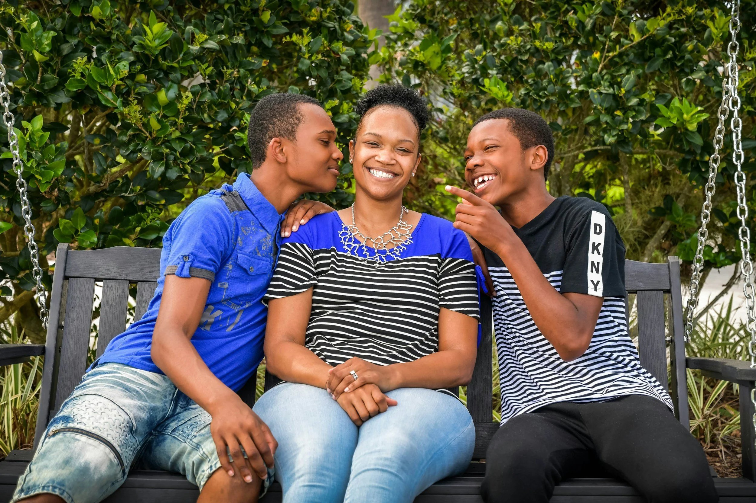 Mother and her sons in park discussing teenagers and mental health issues