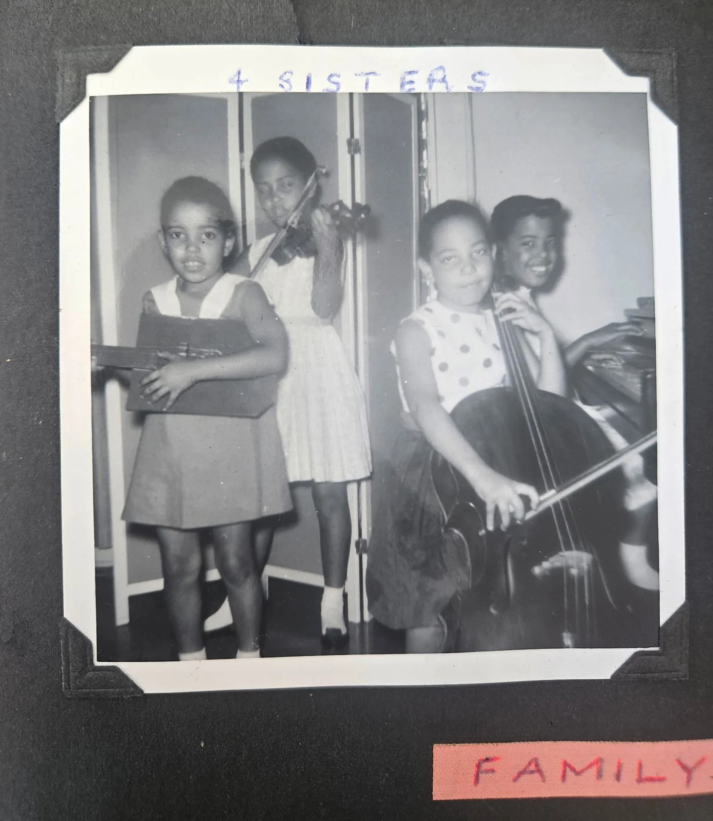4 Sisters: Teri (homemade guitar by their father so she could be part of the Musical Terry Sisters), Lesa (violin), Zela (cello) and Mona (piano)