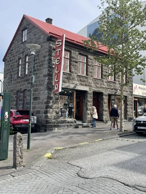 Dark volcanic-stone façade and arched windows in Reykjavík.