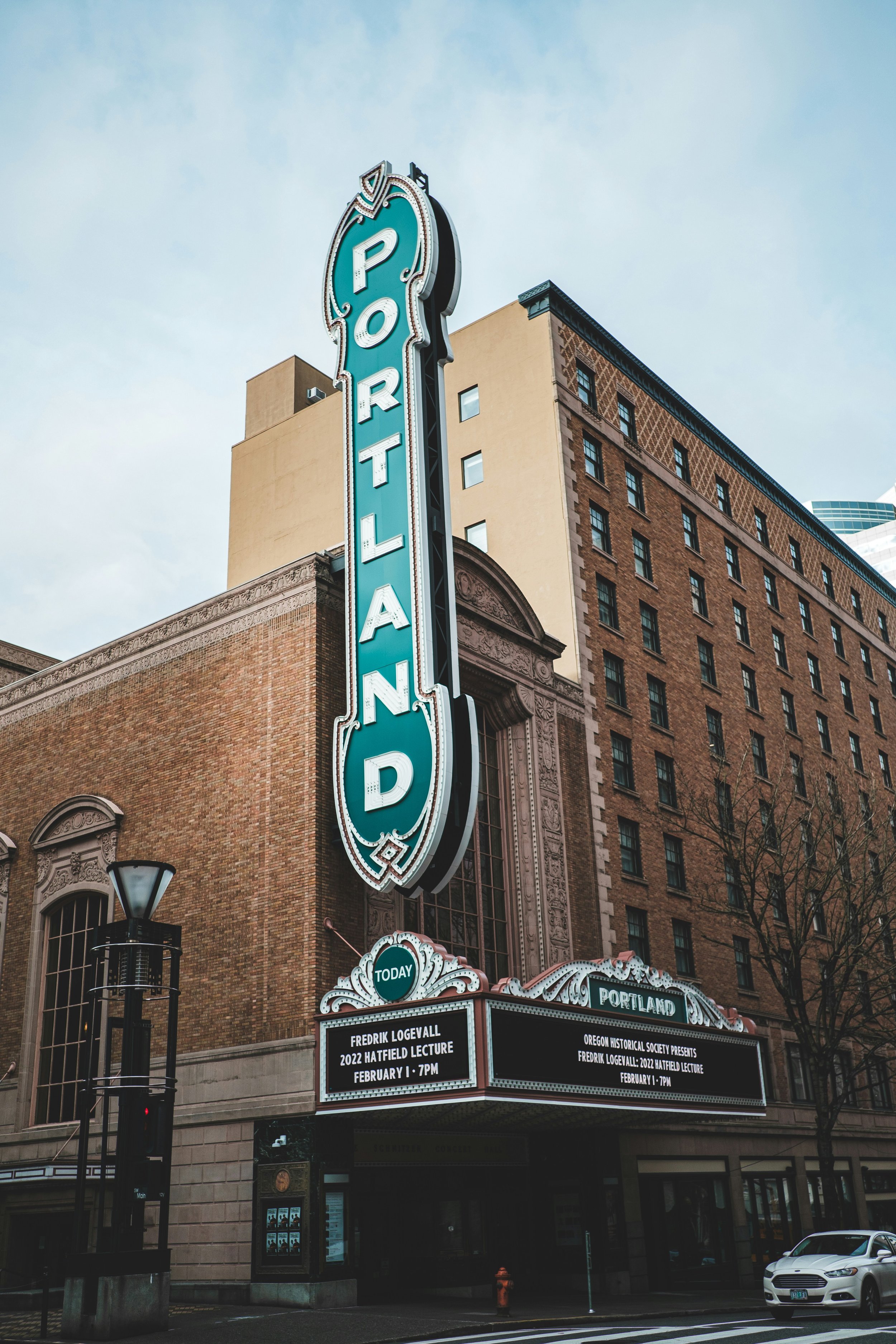 Historic masonry building beneath the Portland sign in downtown Portland, Oregon, illustrating the importance of understanding seismic risks associated with older unreinforced masonry structures in the Pacific Northwest.