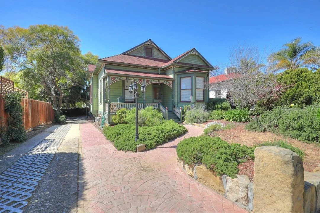 Restored Victorian-style home in Santa Barbara featuring historic architectural detailing, covered front porch, decorative trim, and upgraded residential landscaping.