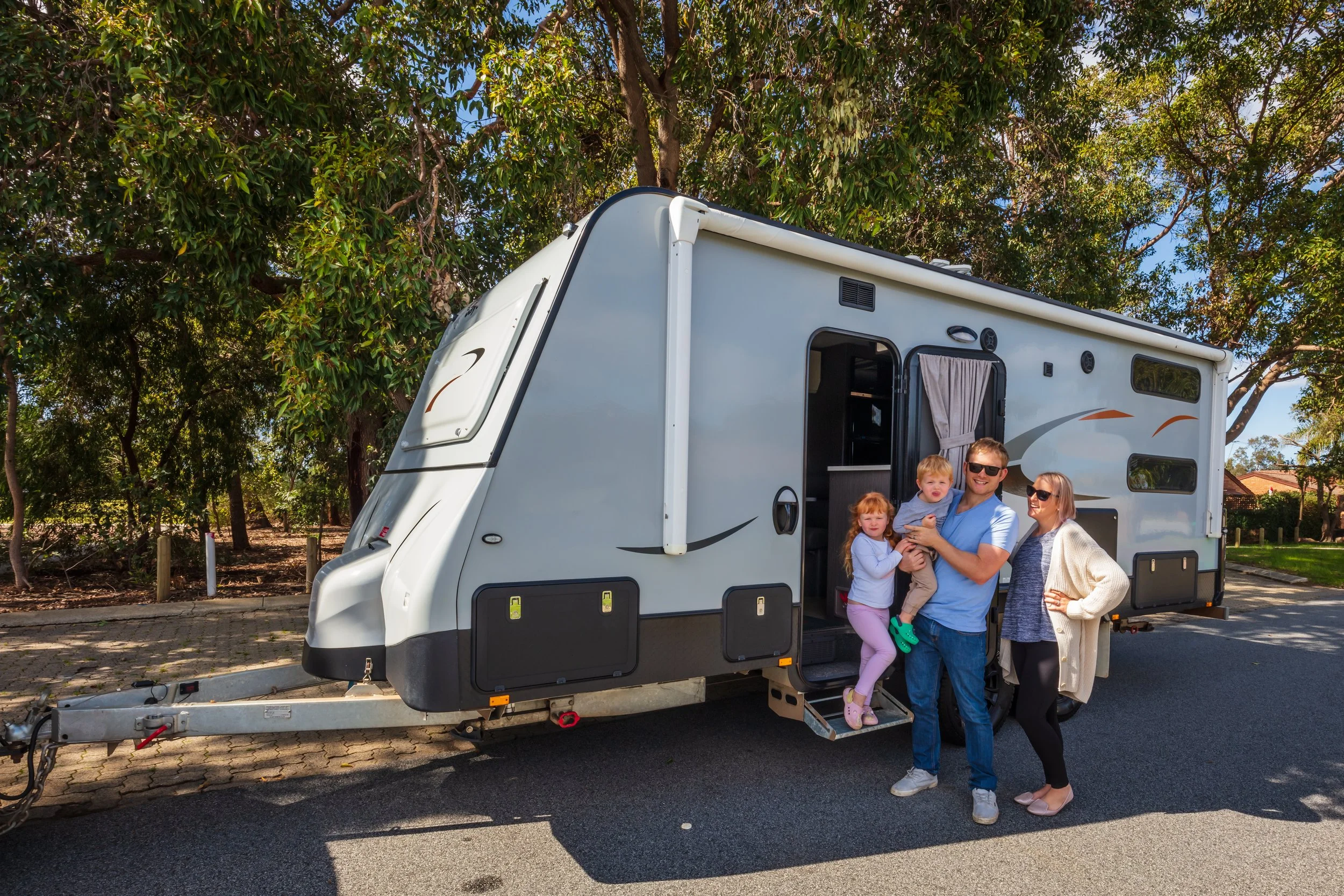 A family standing in front of their new caravan