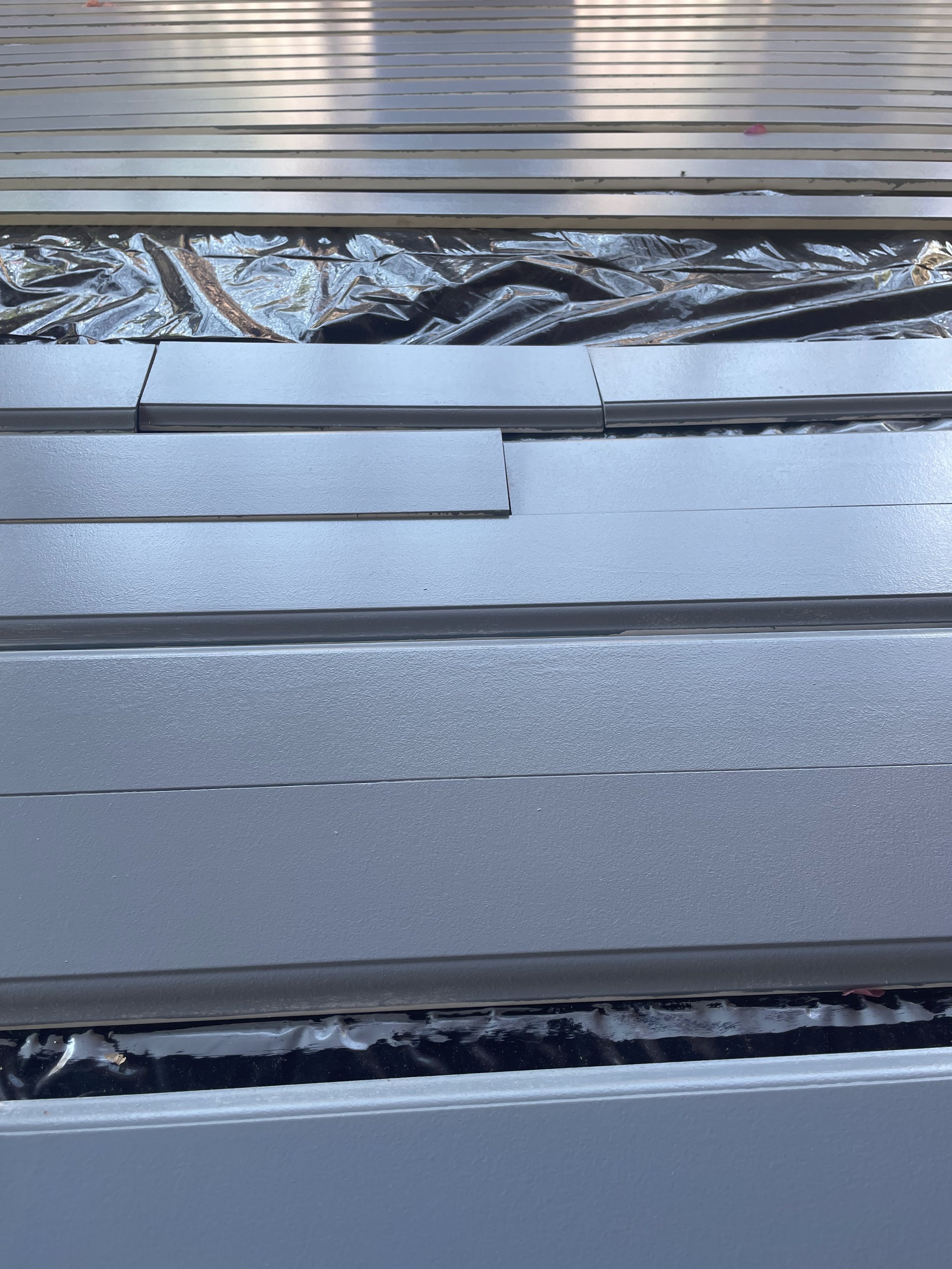 Close-up of interior trim pieces being laid out and painted in preperation for installation.