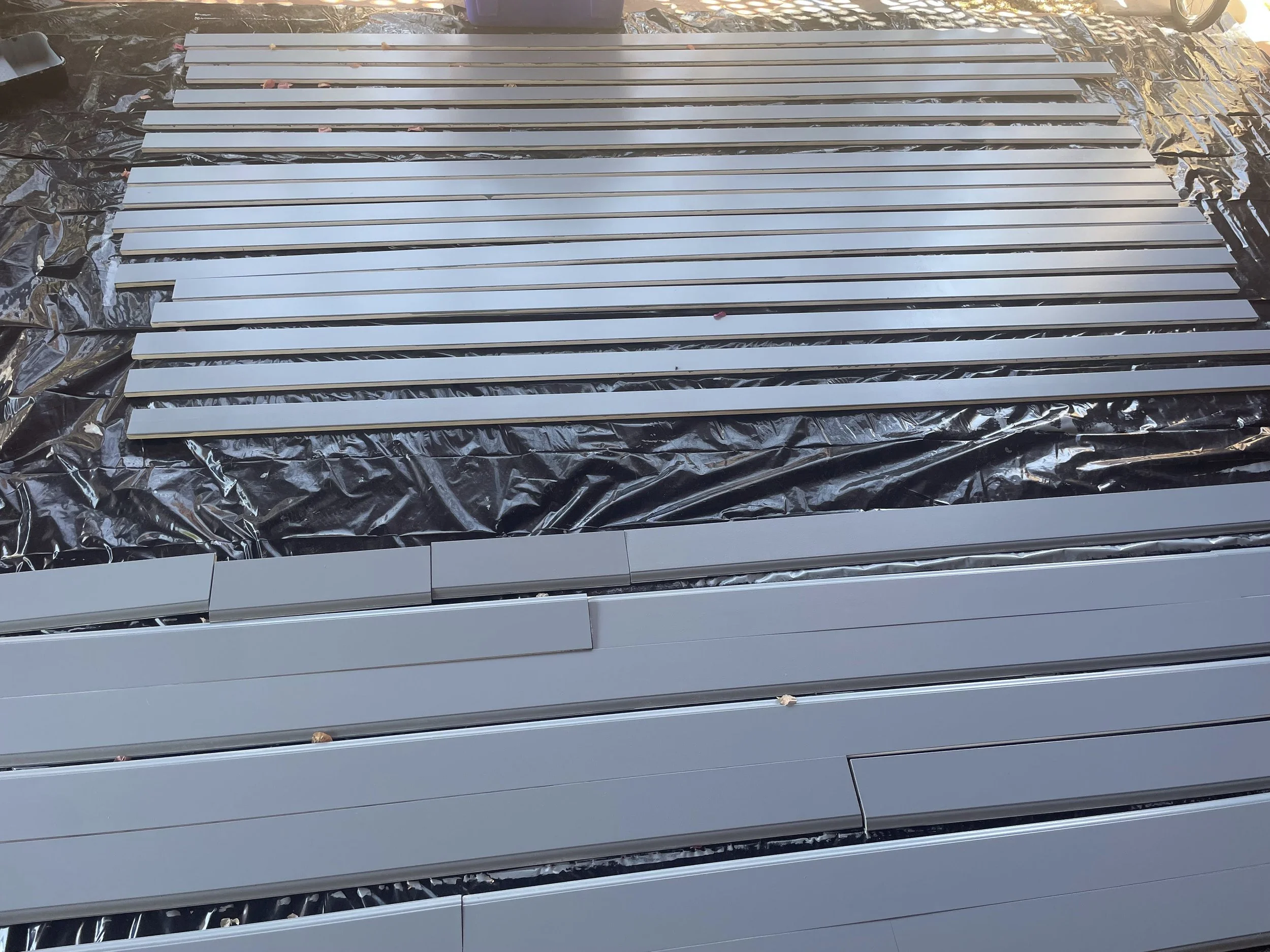 Wood trim pieces being painted in preperation for installation.