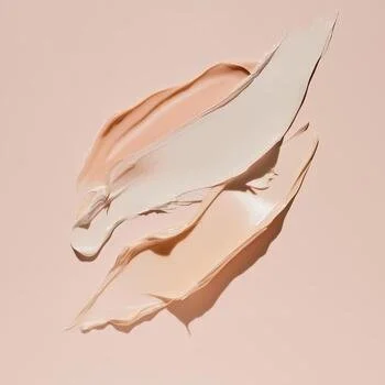Abstract image with flowing, torn paper-like shapes in soft peach and white tones on a pale pink background.