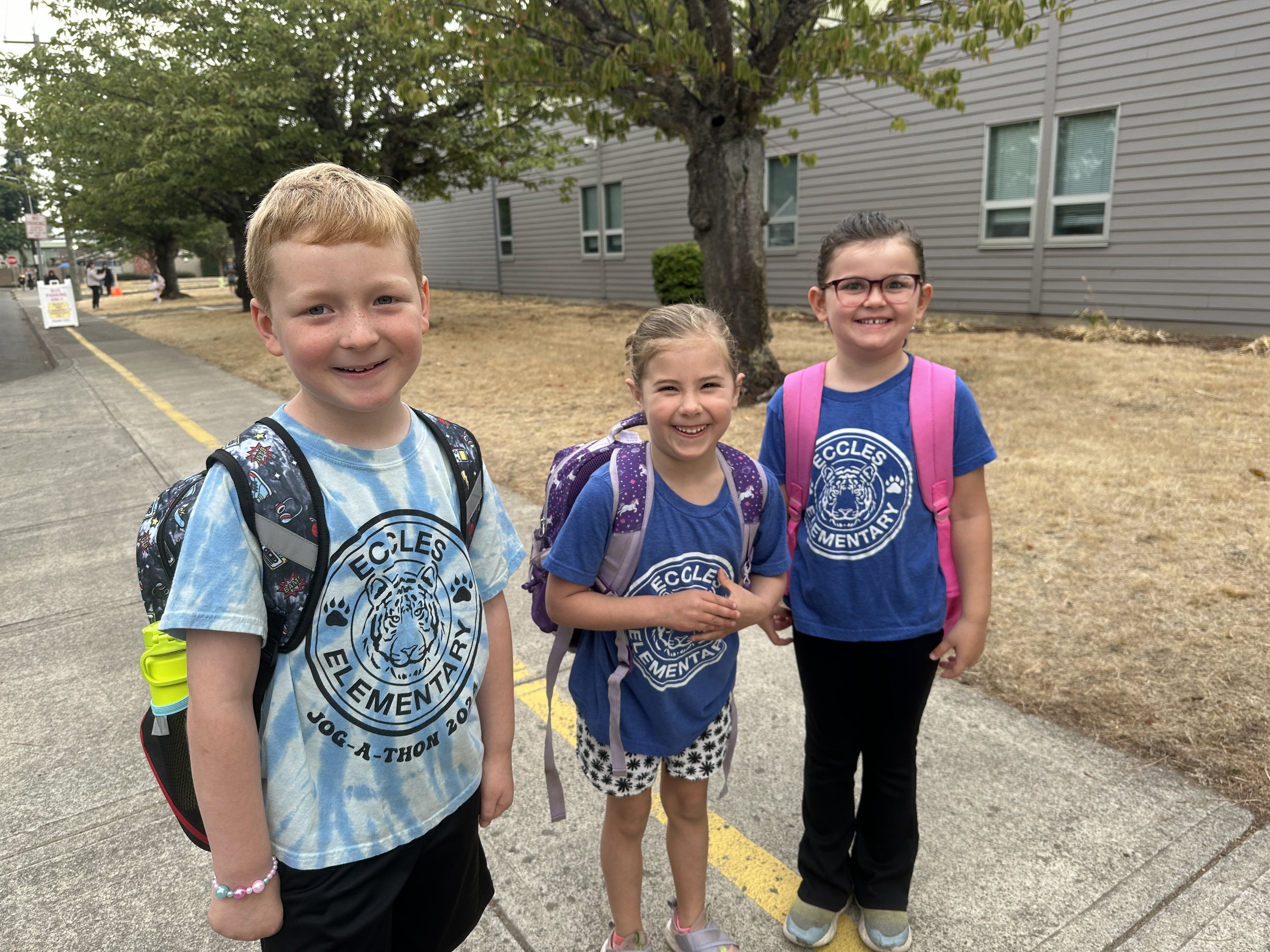 Three kids playing in front of Eccles Elementary