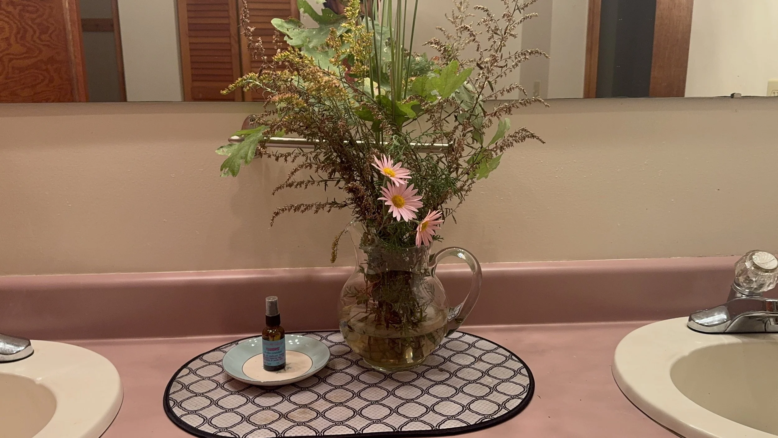 An autumn bouquet and yarrow spray in the bathroom