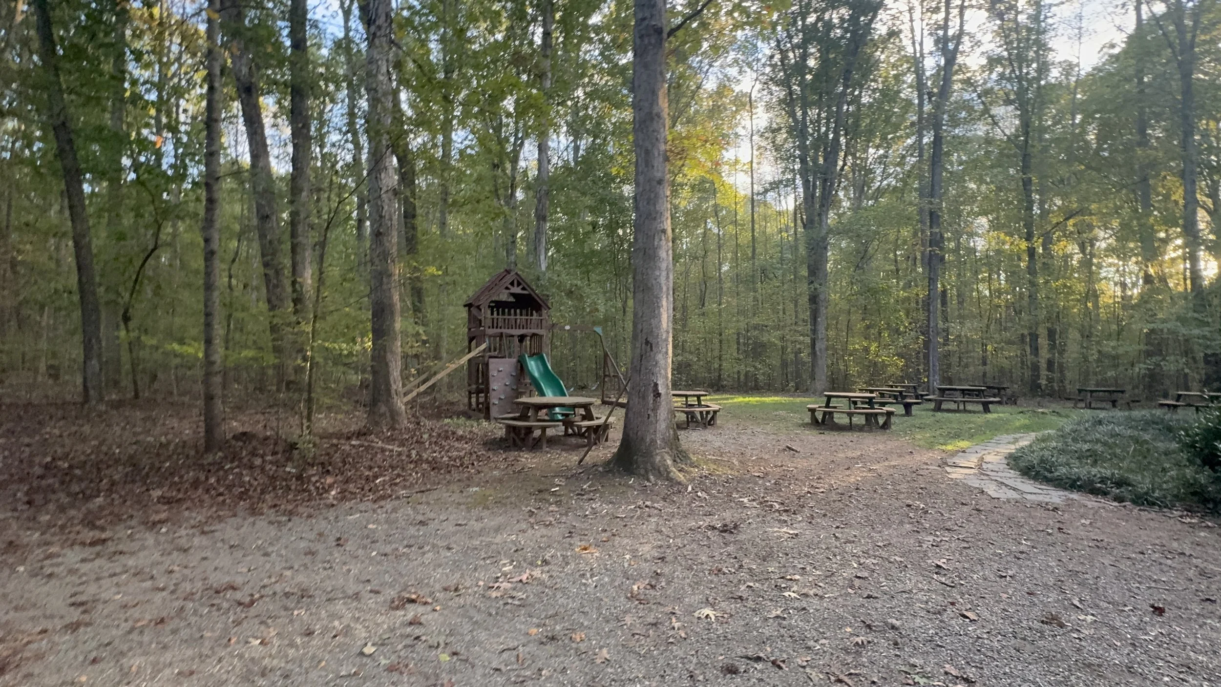 Playground and picnic tables, tent spaces beyond
