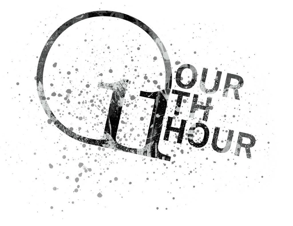 Graphic with a large clock face and the text 'Our 1th hour' in a splattered black and white design.