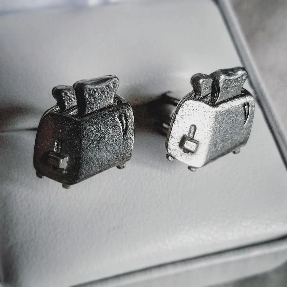 Two vintage metal alarm clocks with locked icons on their fronts, placed on a white textured surface.